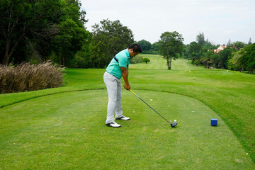 Blurred golfer playing golf in beautiful golf course in the evening golf course with sunshine in...