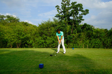 Blurred golfer playing golf in beautiful golf course in the evening golf course with sunshine in...