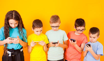 Group of kids using digital mobile phone