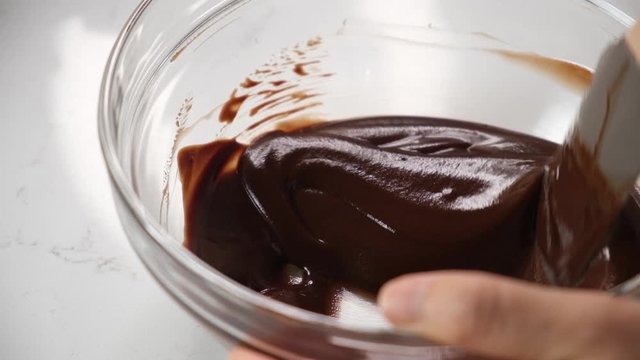 pastry chef preparing chocolate batter for cake and brownies.