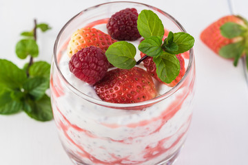 Chia pudding with strawberry sauce and berries.