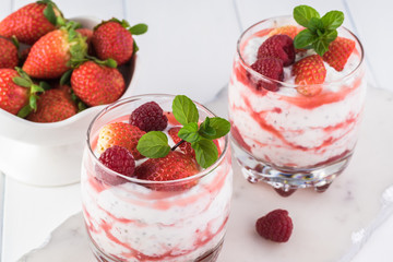 Chia pudding with strawberry sauce and berries.