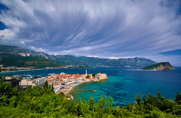 Fototapeta na wymiar Aerial panoramic view of Old town Budva: Ancient walls and red tiled roof. Montenegro, Europe. One of best preserved medieval cities in the Mediterranean and most popular resorts of Adriatic Riviera..
