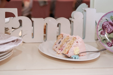 A piece of cake on a plate next to the inscription Family