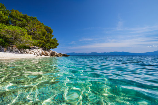 Amazing seascape of Adriatic sea. Luchica beach Croatia, Europe. Colorful summer view of small beach. Croatian coast with clear water and pine trees around. Tropical viewpoint for design postcard.