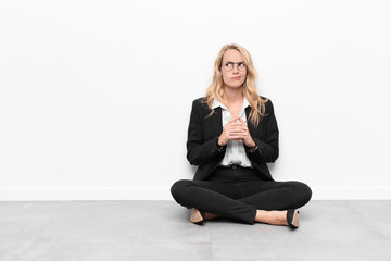 young blonde woman scheming and conspiring, thinking devious tricks and cheats, cunning and...