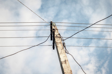 Old concrete electric pole with wires. Look up to the sky