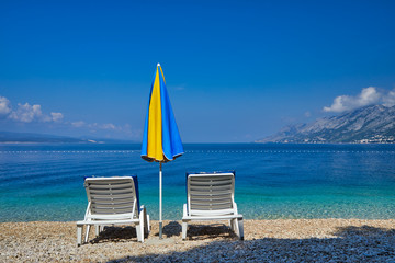 Amazing seascape of Adriatic sea. Colorful summer view of small Brela beach Croatia, Europe. Croatian coast with clear water and pine trees around. Tropical viewpoint for design postcard.