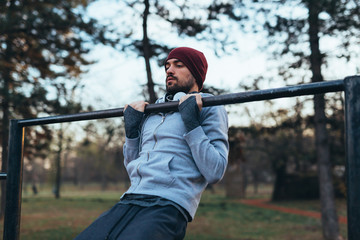 young man outdoor workout in outdoor gym