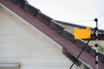 high electric fence with blank yellow tag, security fence for house.