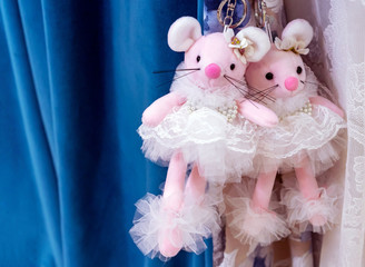 Two pink toy mice in lace white dresses.