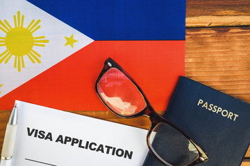 Flag of Philippines  , visa application form and passport on table