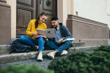 university students talking outdoors by the building