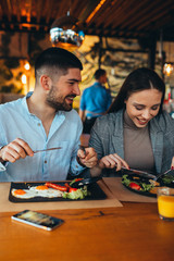 romantic couple eating in restaurant