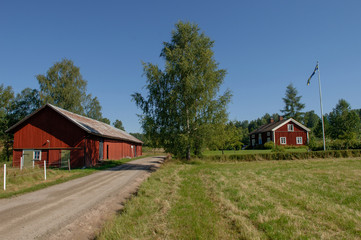 Fototapeta na wymiar old wooden house in the countryside with red barn