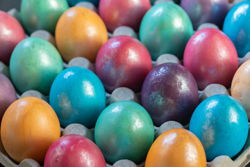 Easter background with hand painted purple, blue, green, orange