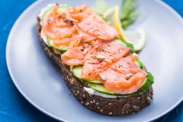 Sandwich with smoked salmon and cucumber. Concept for healthy nutrition.