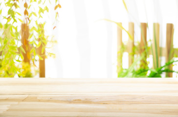 Emty wood table  with garden background close-up look at wooden in morning bright  for product display or design key visual layout