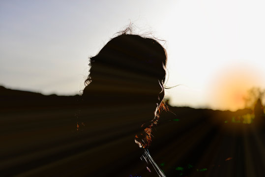Young woman silhouette against saky background