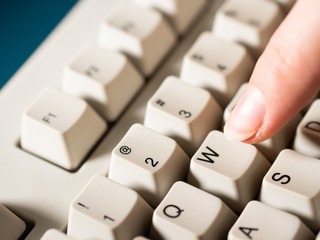 Female forefinger pushes W button. Close-up