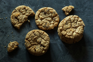 Fresh chocolate chip cookies with chocolate on a dark background food sweet