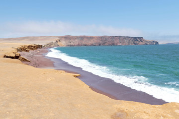 Fototapeta na wymiar Beautiful view from the shore of the red beach in Paracas, it is an important tourist center. Ica-Peru