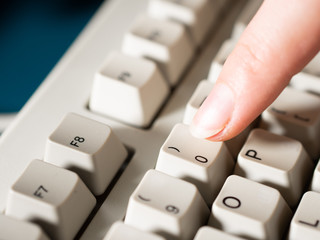 Female forefinger pushes 0 button. Close-up