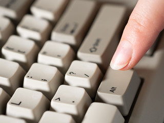 Female forefinger pushes LEFT ALT button. Close-up