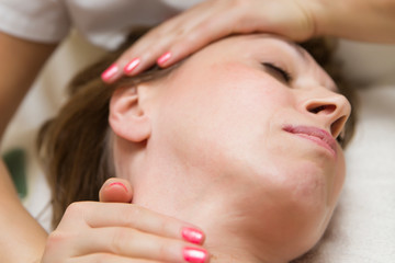 Closeup face of  a woman having facial massage at spa