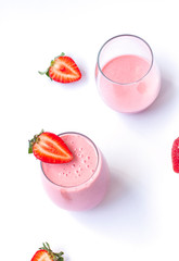 Fresh healthy strawberry smoothie in  transparent glasses. Morning breakfast concept close up on the white background