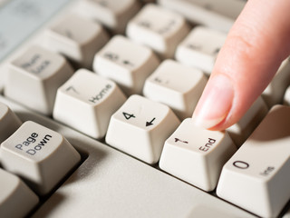 Female forefinger pushes 1 NUMPAD button. Close-up