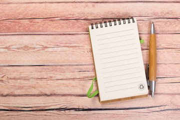 blank notebook with pen on a wooden table, business concept concept of a new workplace