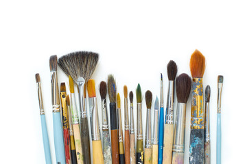 Used artistic paintbrushes isolated on white background. Close up shot of artist's equipment. Copy...