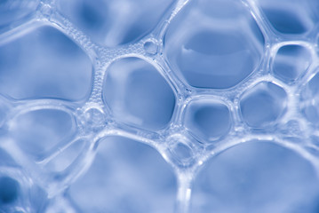 Micrograph of foamy chemical fluid. The chain of compounds of microparticles