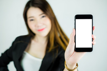 Portrait of stressed asian business woman showing empty white mobile screen. Caucasian female model isolated on white background. selective focus
