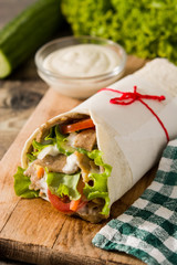 Doner kebab or shawarma sandwich on wooden table