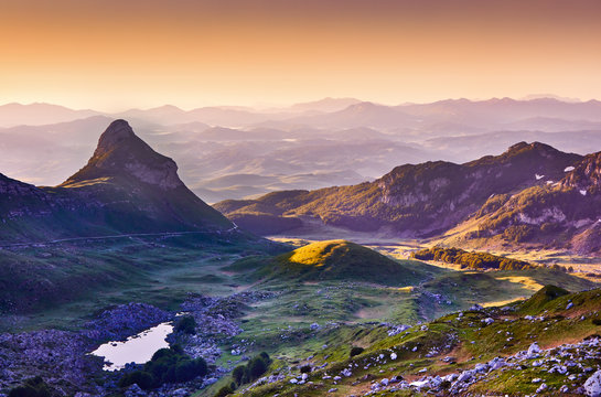 Amaizing sunset view on Durmitor mountains, National Park, Mediterranean, Montenegro, Balkans, Europe.  Bright summer view from Sedlo pass. Instagram picture. Way through the mountain.