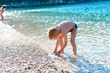 A boy is playing on the beach