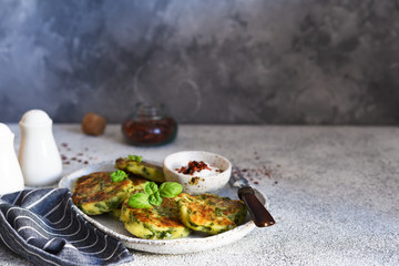Green vegetarian cutlets with spinach on a concrete background.