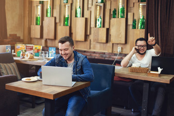 Man with laptop in cafe. Business lunch.