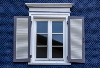 Old wooden window with blinds. No people. Front view. Old fashioned style.