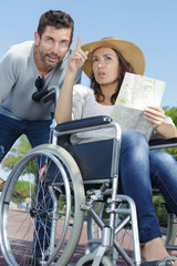 woman in wheelchair pointing into distance