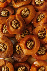 Orange quince soaked in sweet syrup. Background of desserts and sweet apples with walnuts