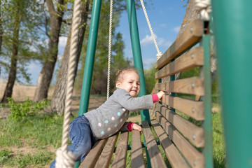 Obraz premium Child swinging a swing. child sitting on a swing