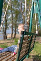 Fototapeta premium Child swinging a swing. child sitting on a swing