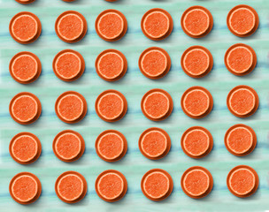 cut orange half on blue wooden board background close up top view photo