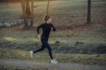 Young athlete exercise at the park. Young woman running at the park