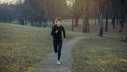 Young athlete exercise at the park. Young woman running at the park