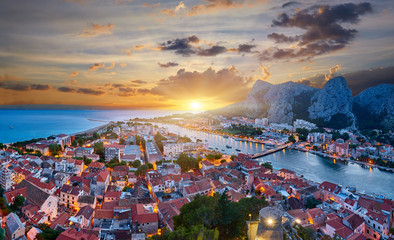 Aerial panoramic view of Old town Omis: Ancient walls and red tiled roof. Montenegro, Europe. One of best preserved medieval cities in the Mediterranean and most popular resorts of Adriatic Riviera.