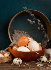 Chicken  and  Quail eggs on a plate with willow